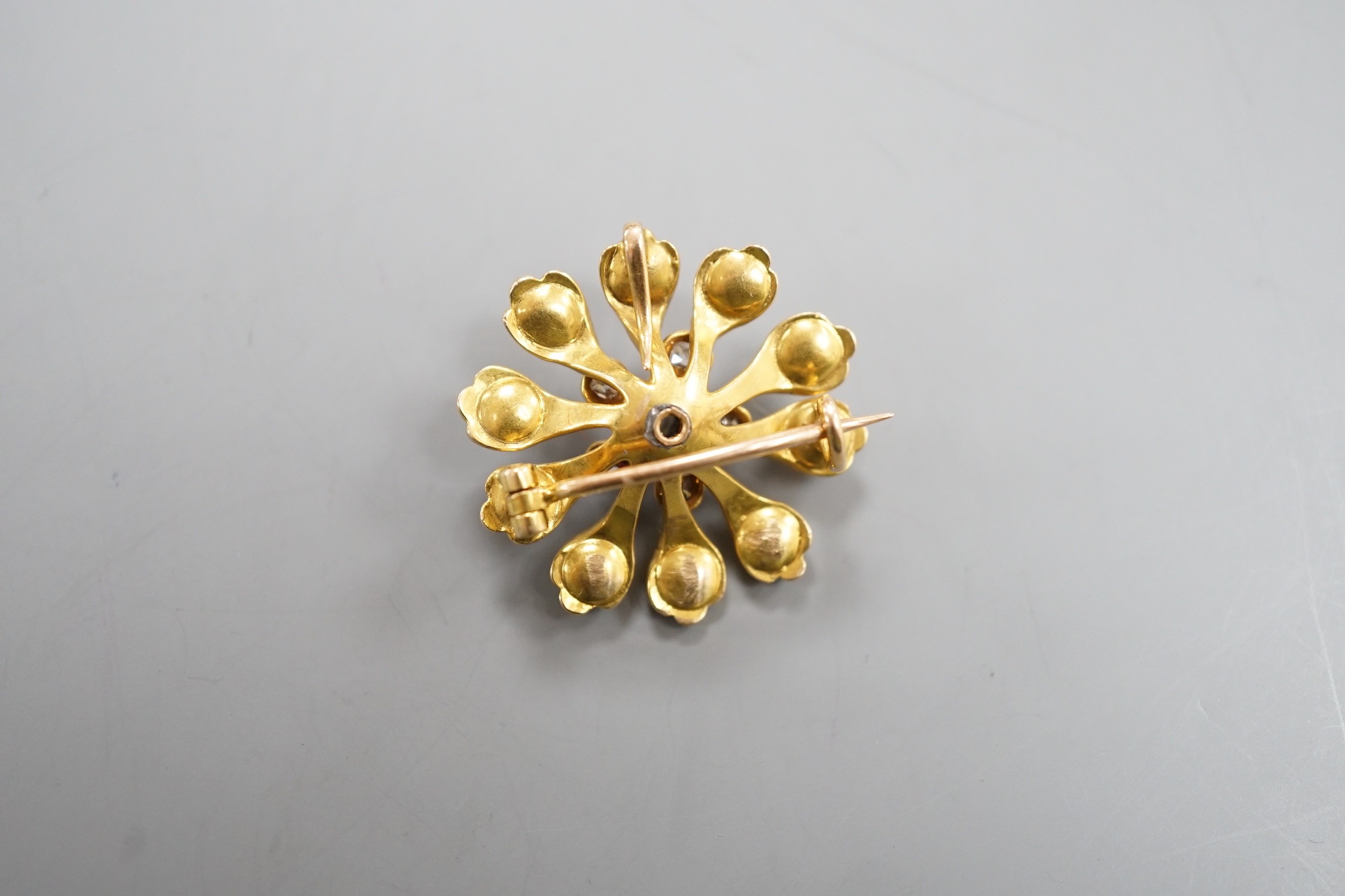A Victorian yellow metal (tests as 15ct), diamond and split pearl set pendant brooch, 26mm, gross weight 6.9 grams.